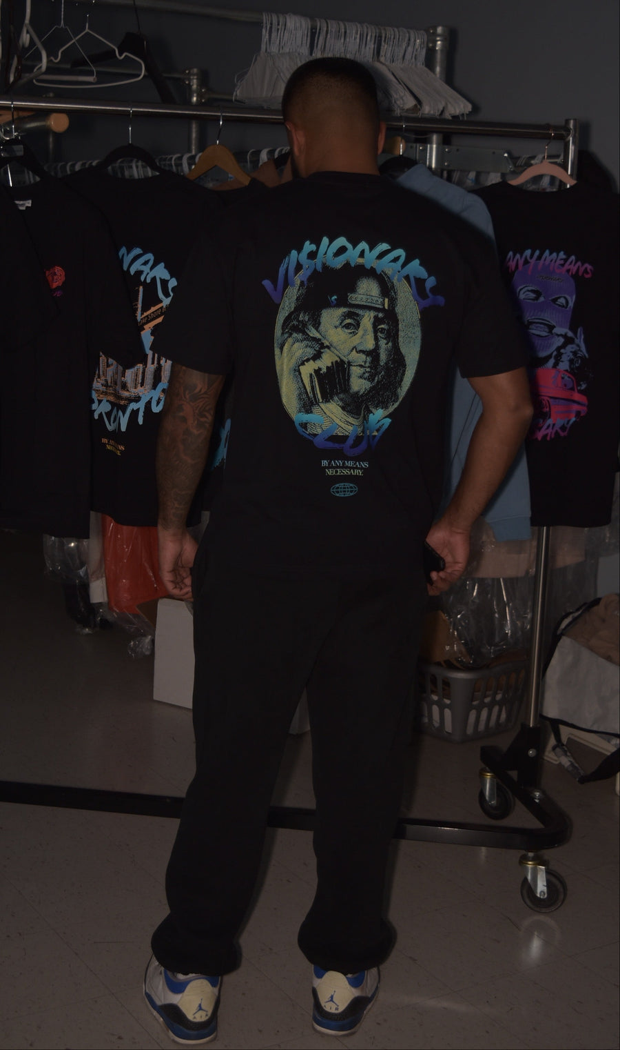 Person wearing a black t-shirt with a graphic design in a store setting