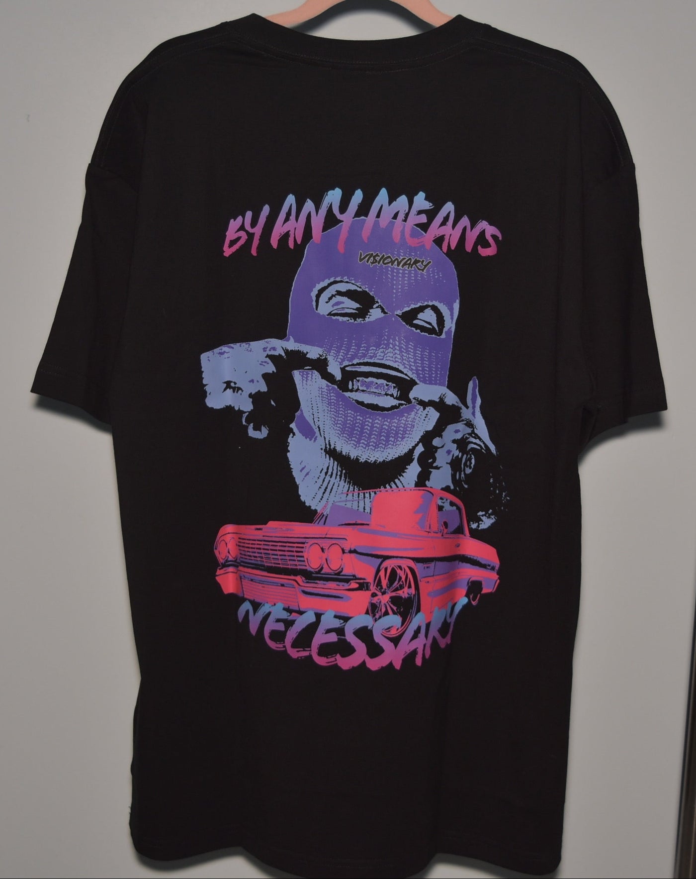 Black t-shirt with graphic design and text on a gray background