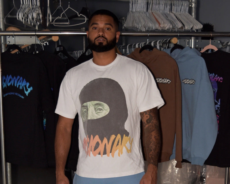 Man wearing a white t-shirt with graphic design in a clothing store