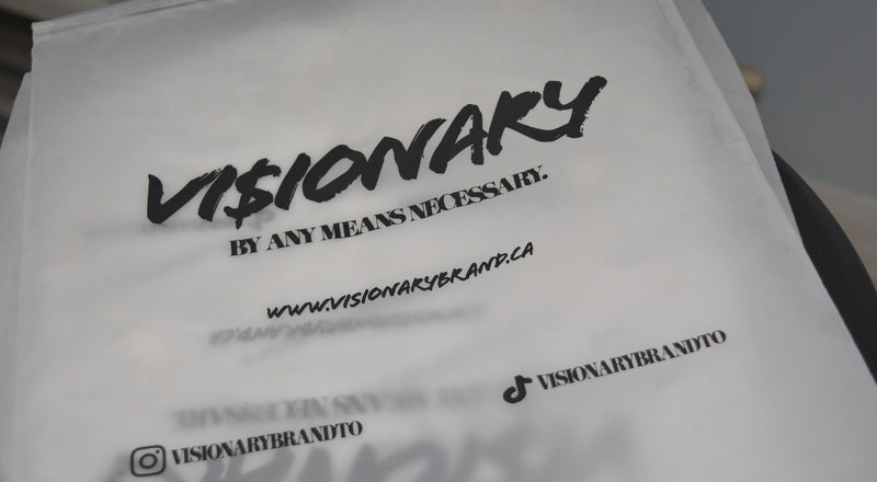 White apron with black text and branding on a neutral background